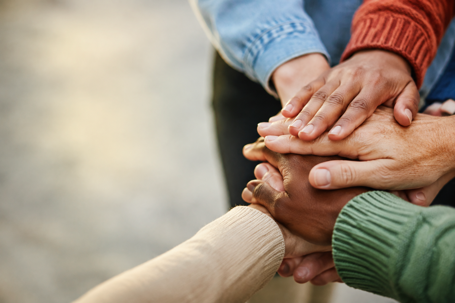 Diverse hands joined together in partnership